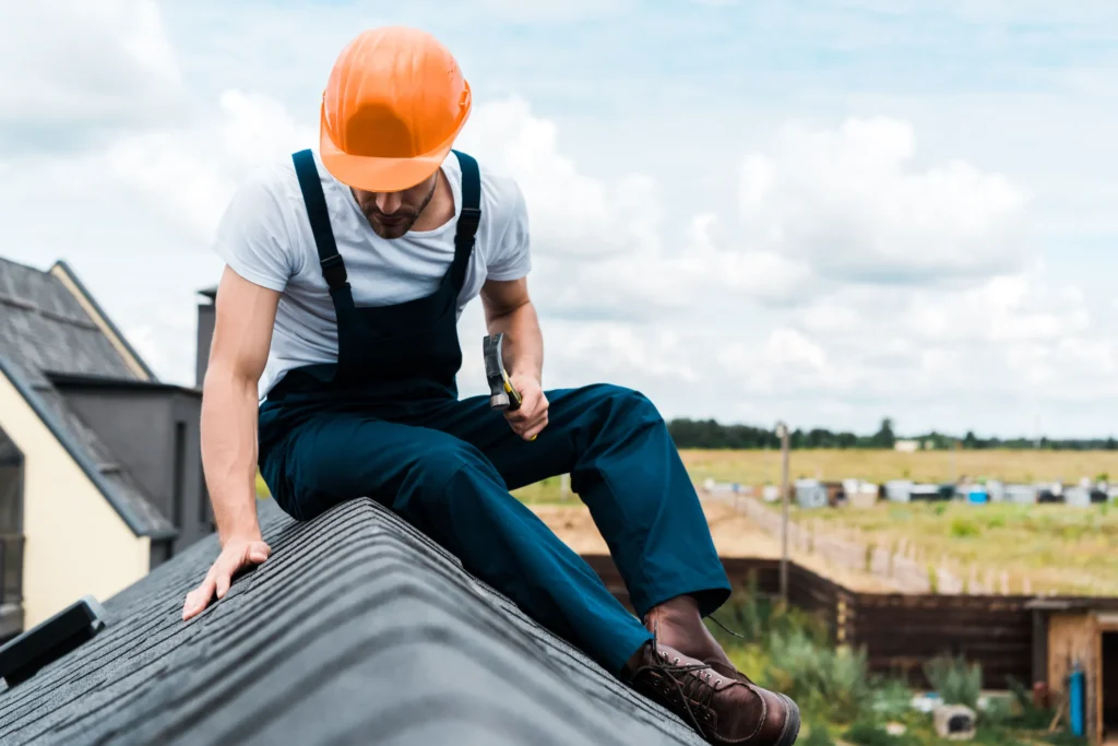 image of a emegency roof repair profeshional setting down on roof